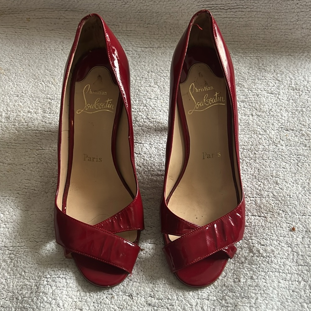 Christian Louboutin red patent leather pumps with wooden heel.